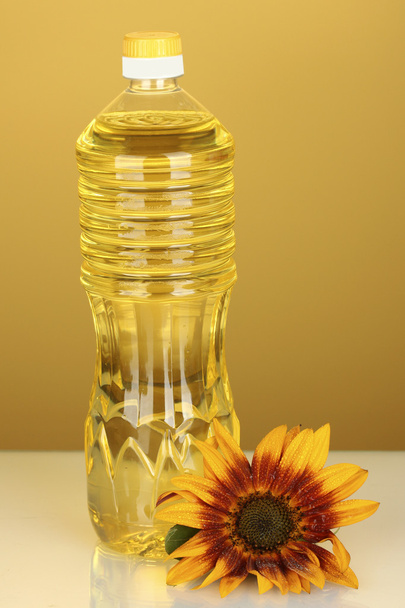 Sunflower oil in a plastic bottle on yellow background - Zdjęcie, obraz