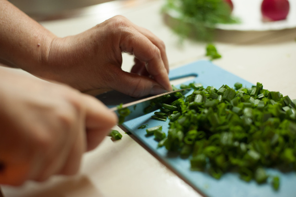 Woman cutting vegetables with a knife - Фото, зображення
