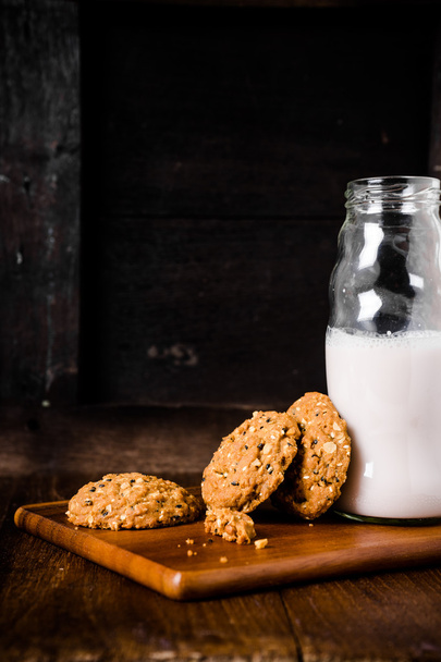 Stack of whole grains cookies with milk bottle - Photo, Image