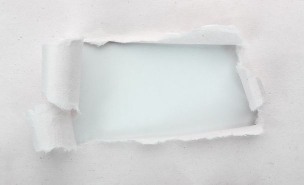 Torn paper with light blue background - Foto, imagen