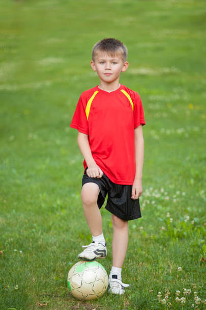 The boy with the ball is on the background of grass - Photo, image