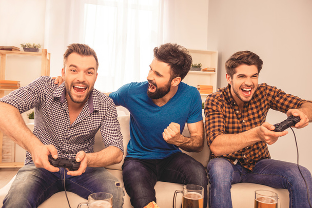 Men's contest! excited happy cheerful man play video game with h - Fotoğraf, Görsel