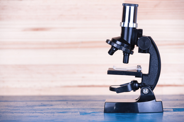 Microscope on a blue natural wooden background. - Photo, Image