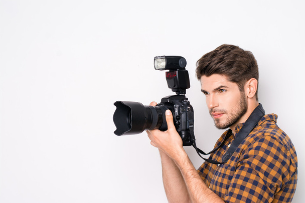 Portrait of young handsome professional photographer taking phot - Фото, изображение