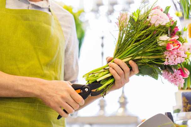 close up of florist man with flowers and pruner - Photo, Image
