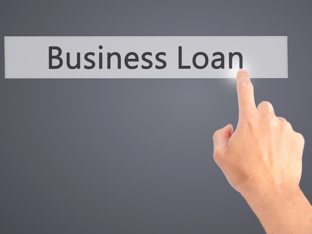Business Loan - Hand pressing a button on blurred background con - Photo, Image