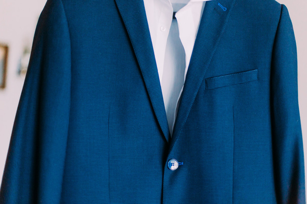 Close-up of expensious blue suit hanging indoors - Photo, Image