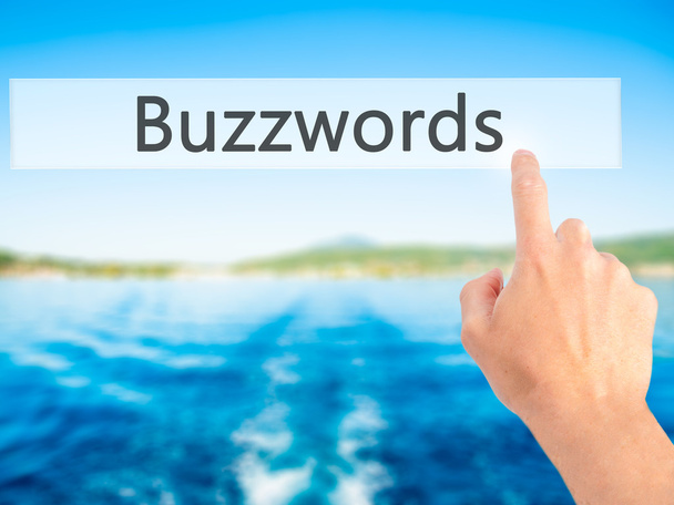 Buzzwords - ręcznie naciskając przycisk na koncepcji niewyraźne tło - Zdjęcie, obraz