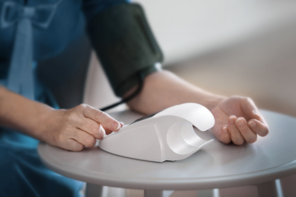 Woman measuring blood pressure  - Foto, Bild
