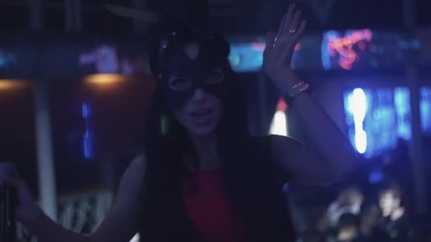 Brunette mc girl in hare mask perform on stage in nightclub. Raise hands. Show - Footage, Video