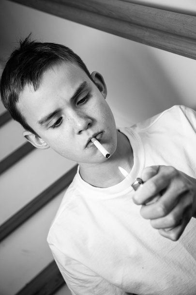 Experimental image of boy lighting cigarette - Photo, Image