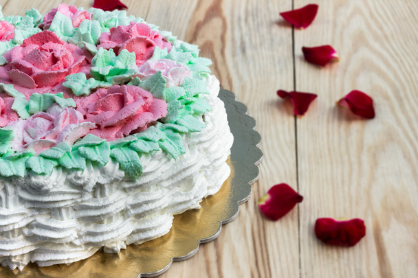 Delicious creamy cake basket of roses (half cake) on  wooden table - Photo, Image