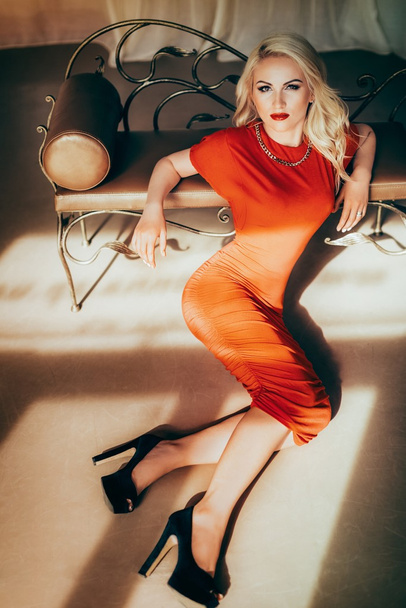Blonde woman with makeup in red dress - Fotoğraf, Görsel