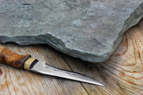 Stone plate(desk) with hunter knife with wooden pen knife.On old - Foto, afbeelding