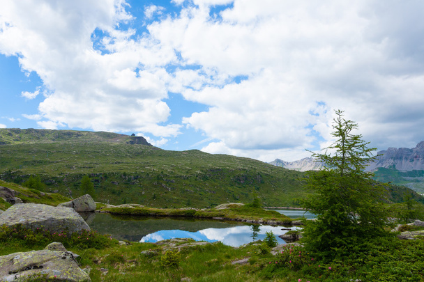 Italian mountain panorama, clouds reflected on alpine lake - 写真・画像