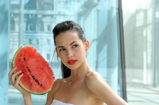 Girl is posing with a slice of red watermelon - Zdjęcie, obraz