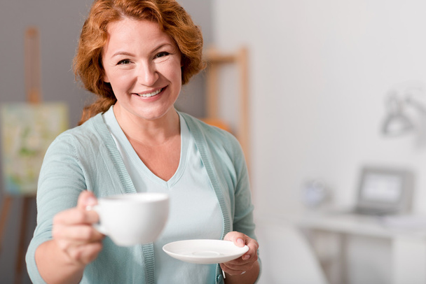 Cheerful woman drinking tea - Fotó, kép