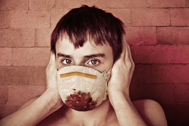 Νέοι έφηβος αγόρι που φοράει το αίμα εμποτισμένο χειρουργική μάσκα - Φωτογραφία, εικόνα