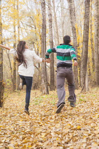 Portrait of Young adult  latin hispanic couple holding hands and running  - Photo, Image