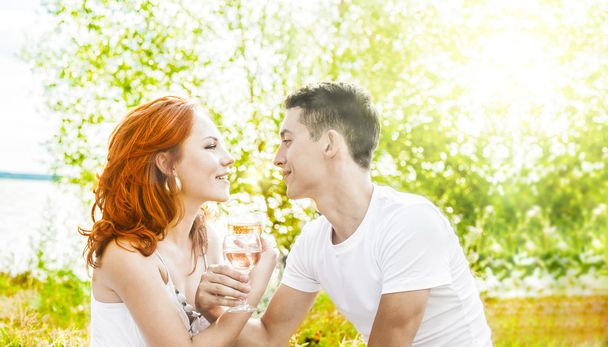 Young happy couple  with champagne or picnic.  - Фото, изображение