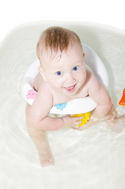 Blue-eyed Baby swimming in the bath - Фото, зображення