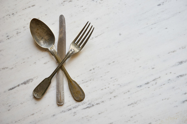 Vintage cutlery on black marble background - Photo, Image
