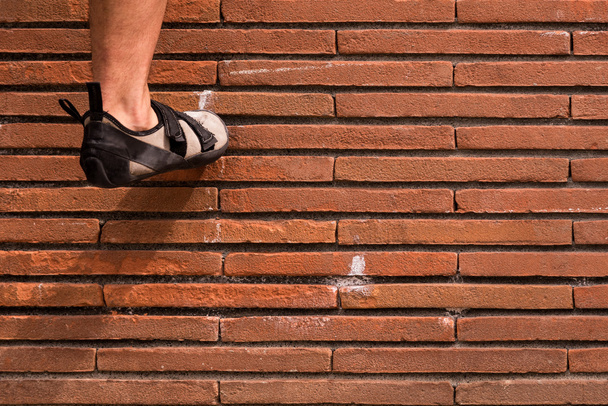 Climbing  a red brick wall - Photo, Image