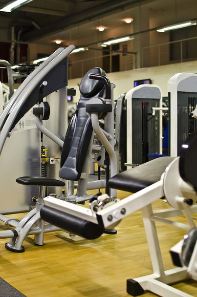 Athletic gym machine in fitness club - Photo, Image