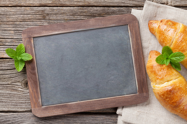 Blackboard and croissants. Top view - Photo, Image