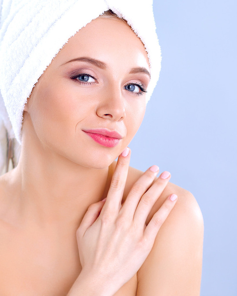 Beautiful woman with a towel on her head on a gray background - Photo, Image