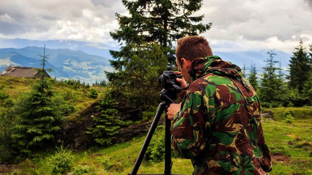 Photographer taking photo of mountain landscape, Carpathian, Ukraine - Zdjęcie, obraz