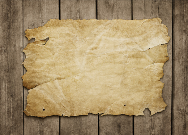 Old paper at grunge wooden background - Photo, Image