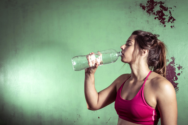 GIrl drinking water after training - Foto, immagini