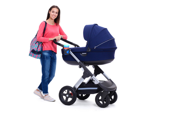 Full length portrait of a mother with a stroller, isolated on white background - 写真・画像