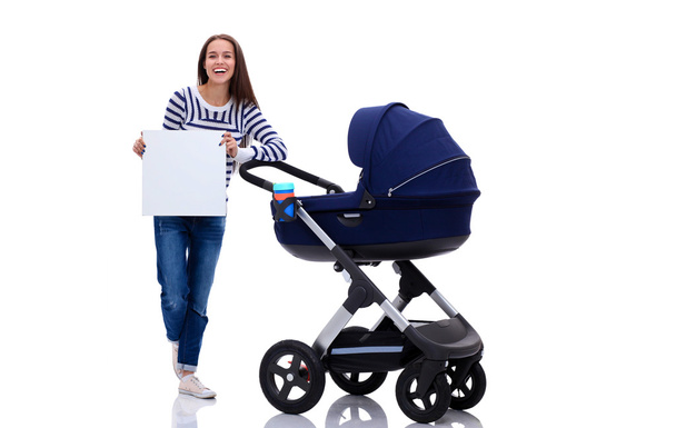 Full length portrait of a mother with a stroller holding blank, isolated on white background - Photo, Image