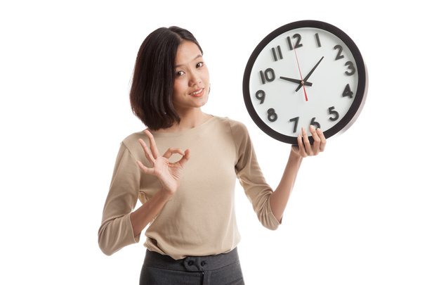 Young Asian business woman show OK with a clock - Φωτογραφία, εικόνα
