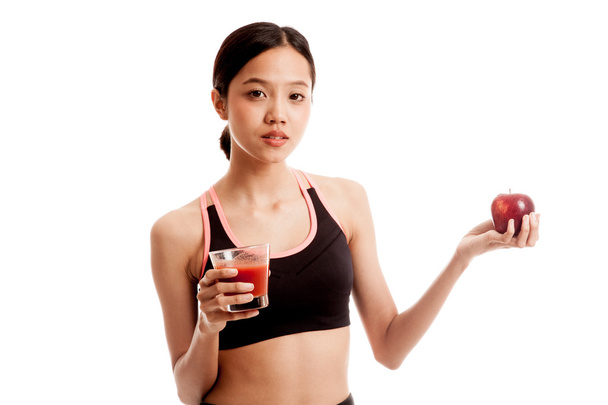 Beautiful healthy Asian girl with tomato juice and apple - Foto, Imagem
