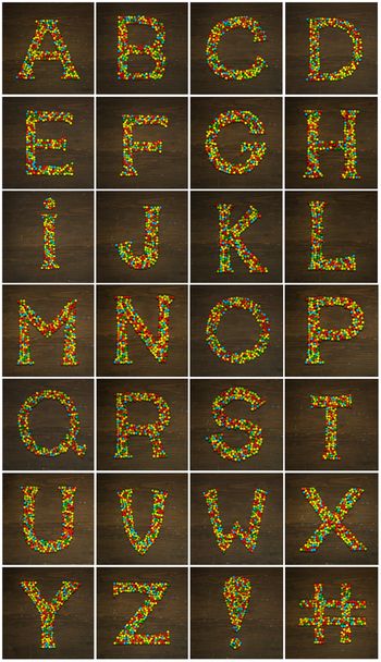 Candy alphabet on a wood - 写真・画像