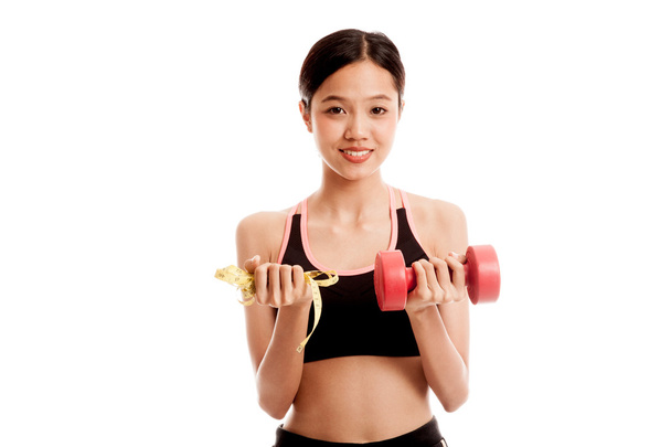 Beautiful Asian healthy girl with dumbbell and measuring tape - Foto, Imagem