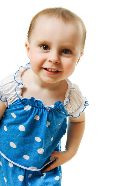 Little girl in blue dress smiling on white background - Фото, зображення