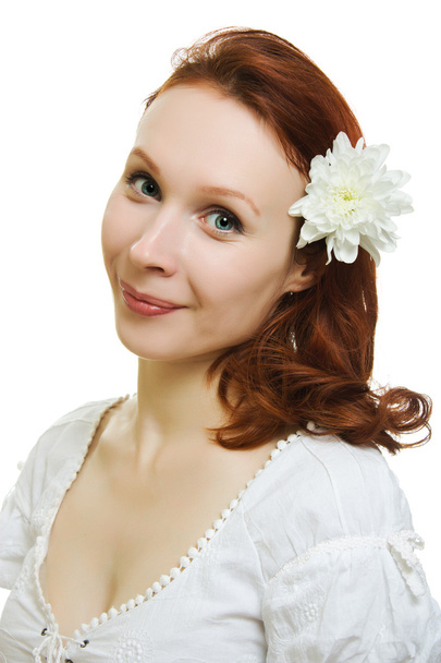 Healthy skin of young beautiful woman face with a flower in her hairs on a white background. - Fotografie, Obrázek
