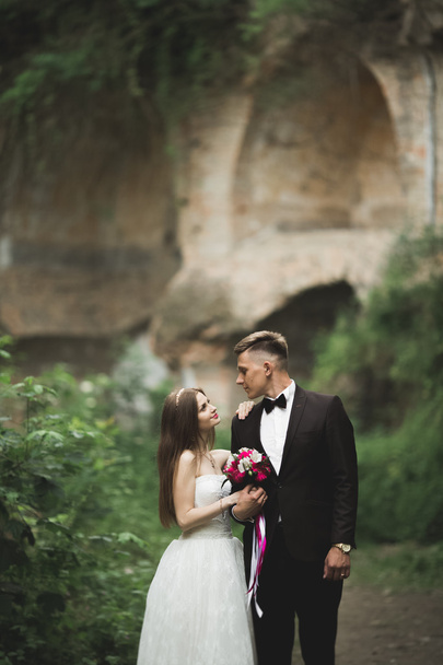 Amazing happy gentle stylish beautiful romantic caucasian couple on the background ancient baroque castle - Photo, image