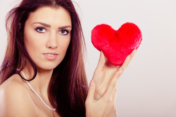 Beautiful woman holds red heart  - Фото, зображення