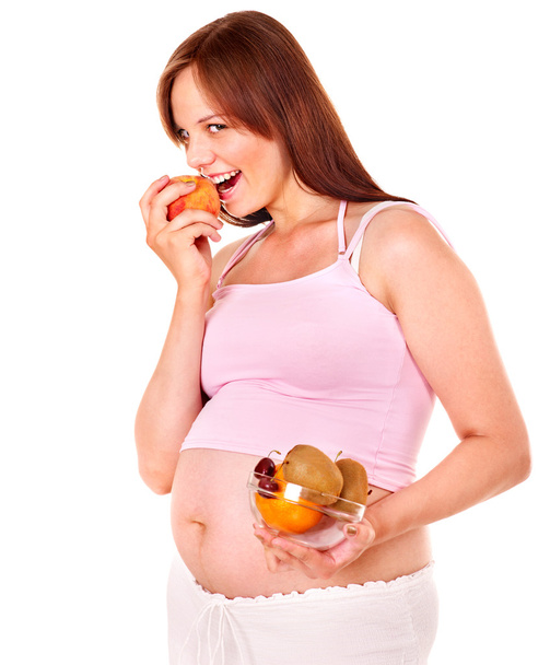 Pregnant woman eating fruit. - Photo, Image