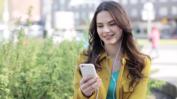 happy young woman with smartphone and headphones - Filmati, video