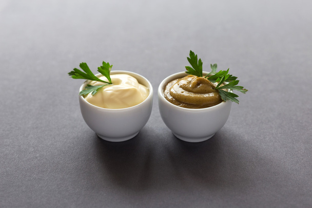 Fresh homemade sauces yellow mustard and white mayonnaise - 写真・画像