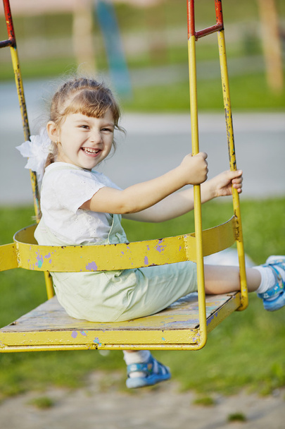 little happy girl on the swings - Φωτογραφία, εικόνα