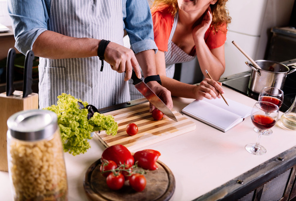 Close up of couple cooking together - Photo, image