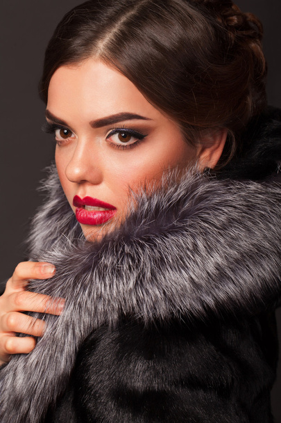 A beautiful young woman dressed in a winter coat - Fotó, kép