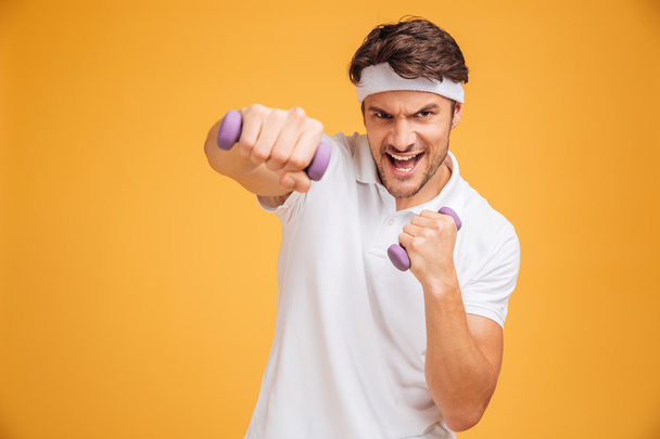 Fitness man working out with small dumbbells - Φωτογραφία, εικόνα
